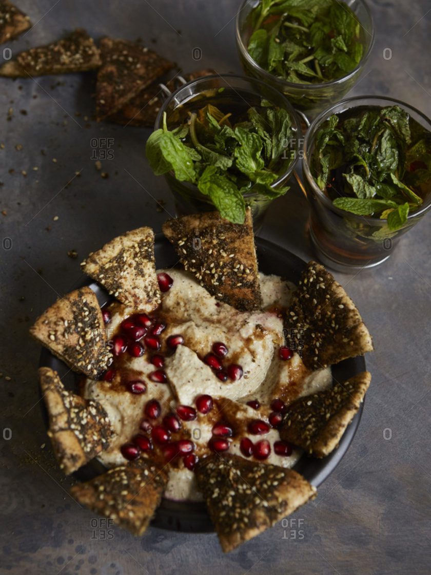 A bowl of food with some crackers and yogurt